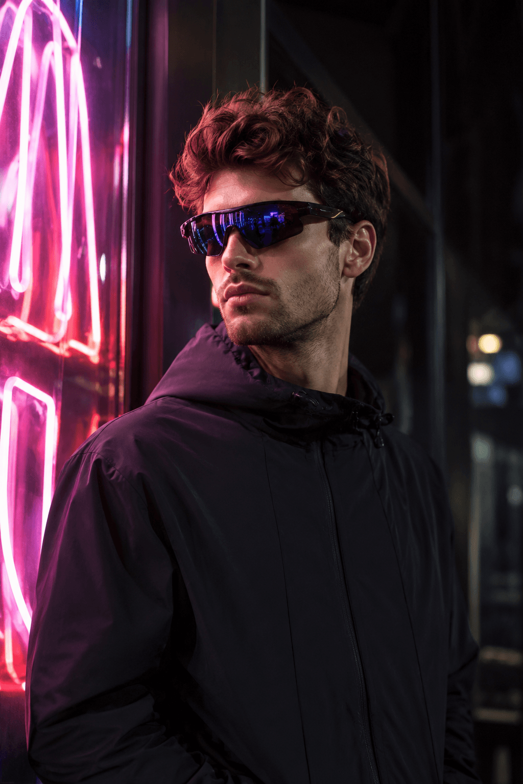 Woman in oversized square sunglasses on a sunlit terrace.